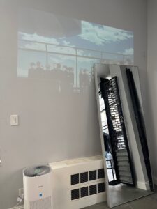 Waiting area of assort new york playing the projector