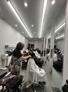 Hair stylist hard at work at Assort New York